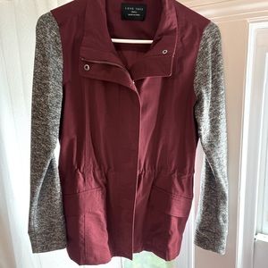 Small jacket. Draw string waste. Knit sleeves.